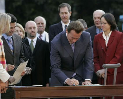 Images of the Governor signing the executive order and reviewing low-carbon-fueled autos
